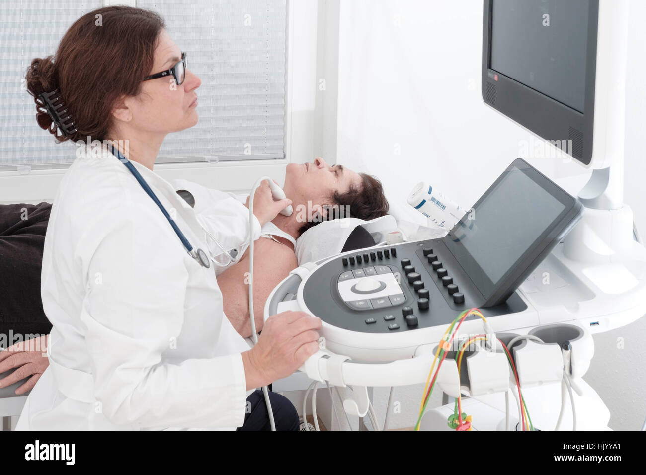 Cardiologist  detecting senior female patients heart risk- echocardiogram of the heart Stock Photo