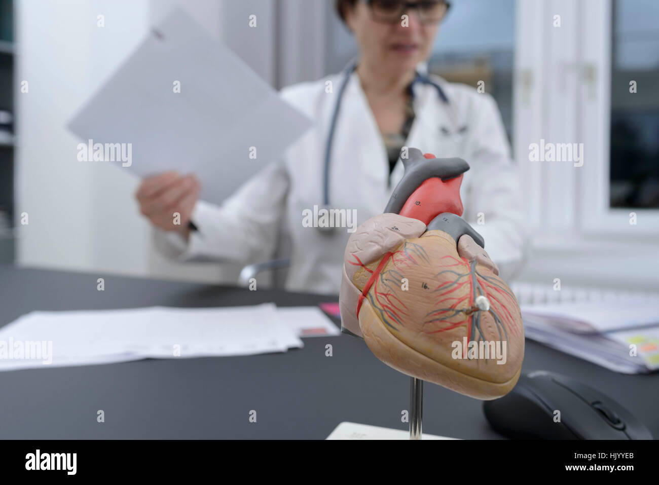 Female doctor sorting out paperwork Stock Photo