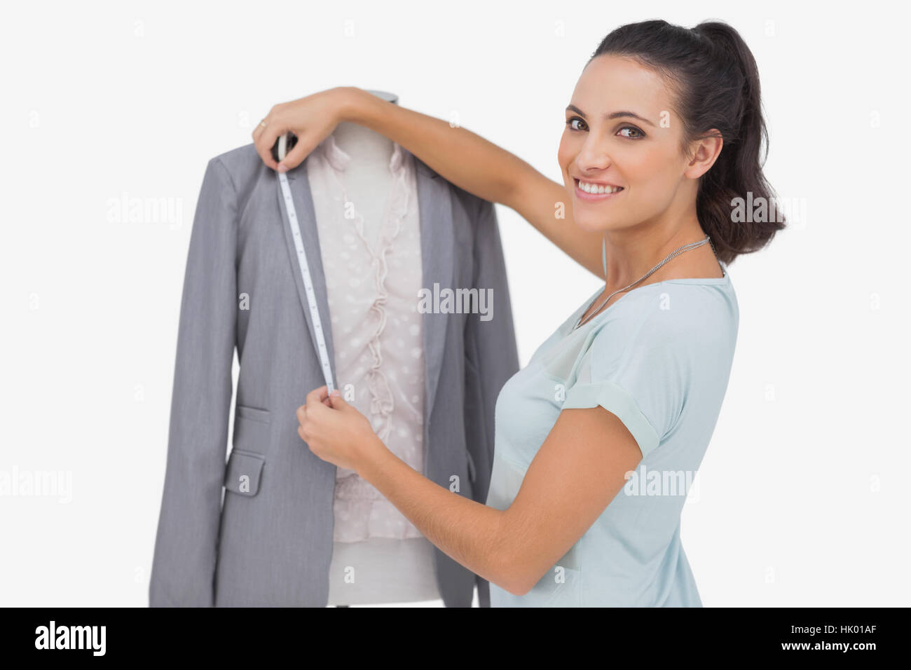 Fashion designer measuring blazer lapel on white background Stock Photo ...