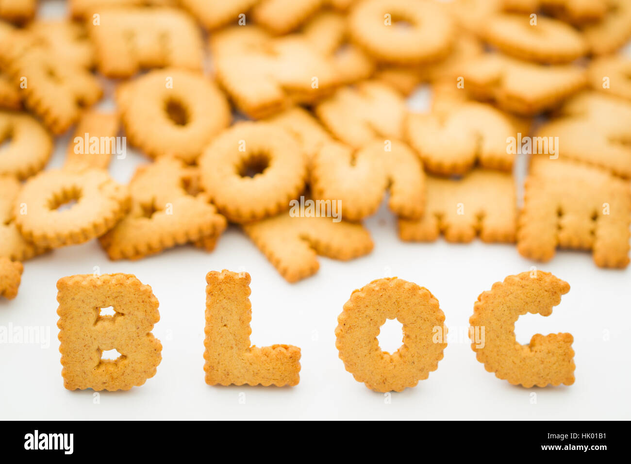 The word blog created from alphabet shaped cookies and biscuits on a white background for a food blogger. Stock Photo