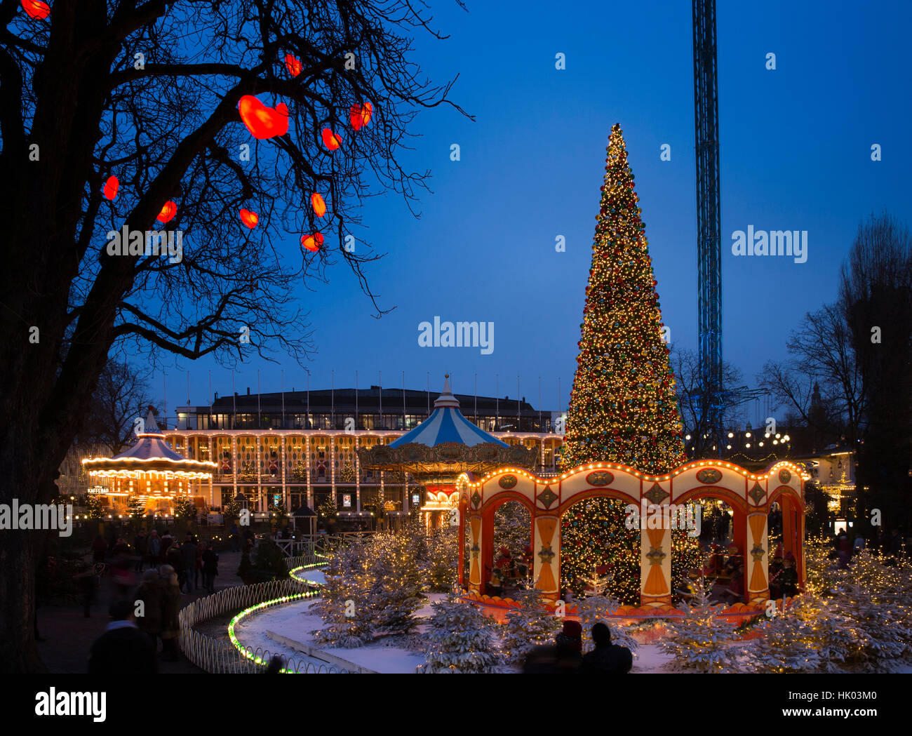 Denmark, Copenhagen, Tivoli Gardens at Christmas, tree decorated with coloured lights at night Stock Photo
