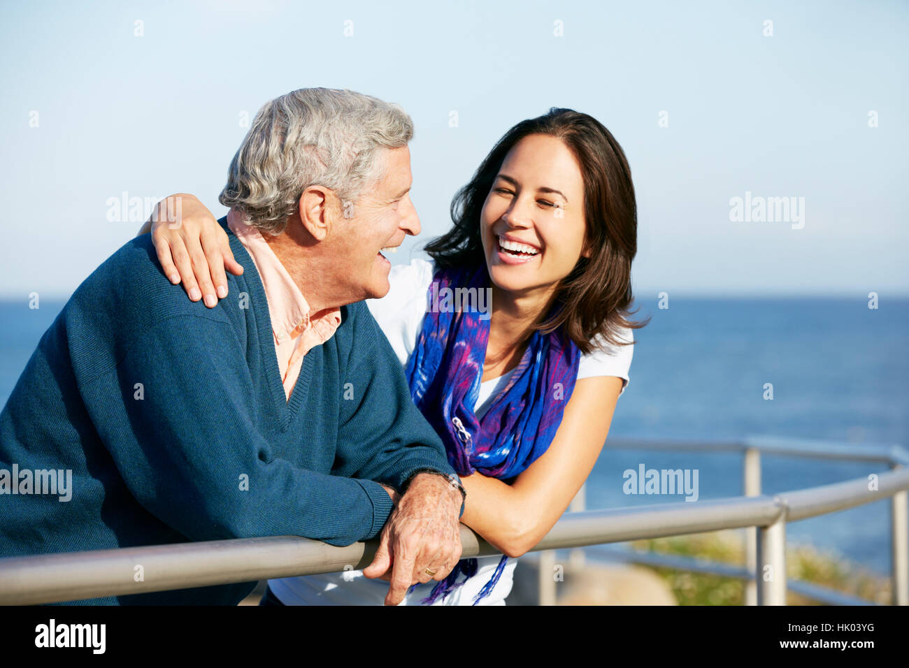 Senior Man With Adult Daughter Looking Over Railing At Sea Stock Photo ...