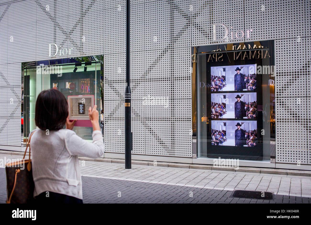 woman taking pictures of the Dior shop, in Ginza. Harumi St.Tokyo city, Japan, Asia Stock Photo