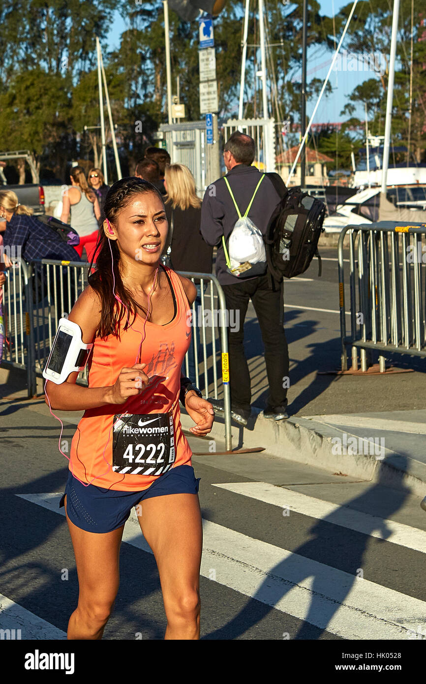 Determined Female Athlete Running In The Nike Woman's Half Marathon, San Francisco, 2015. Stock Photo