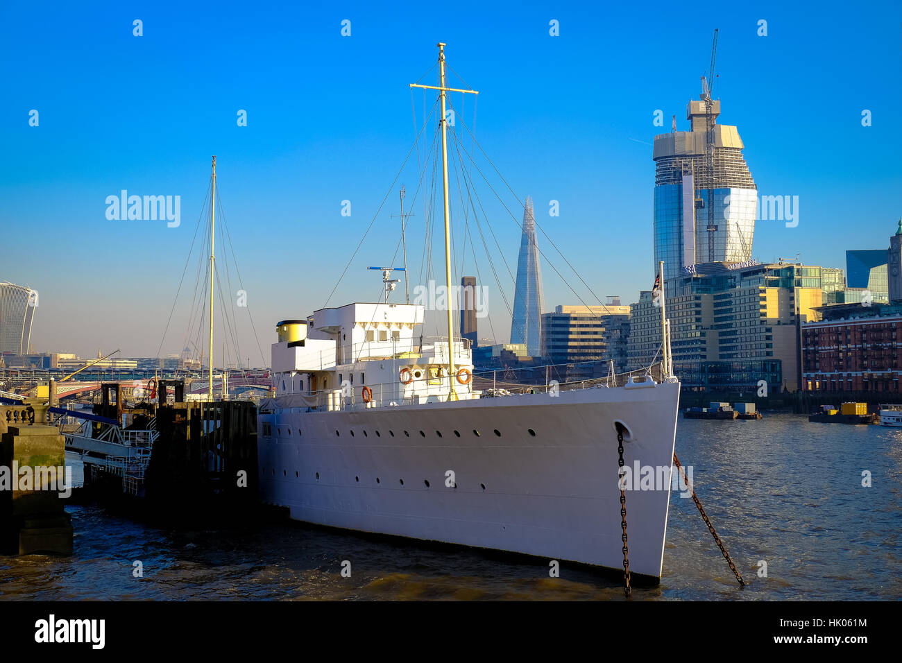 Ship anchored on London's River Thames with skyscrapers in the background Stock Photo
