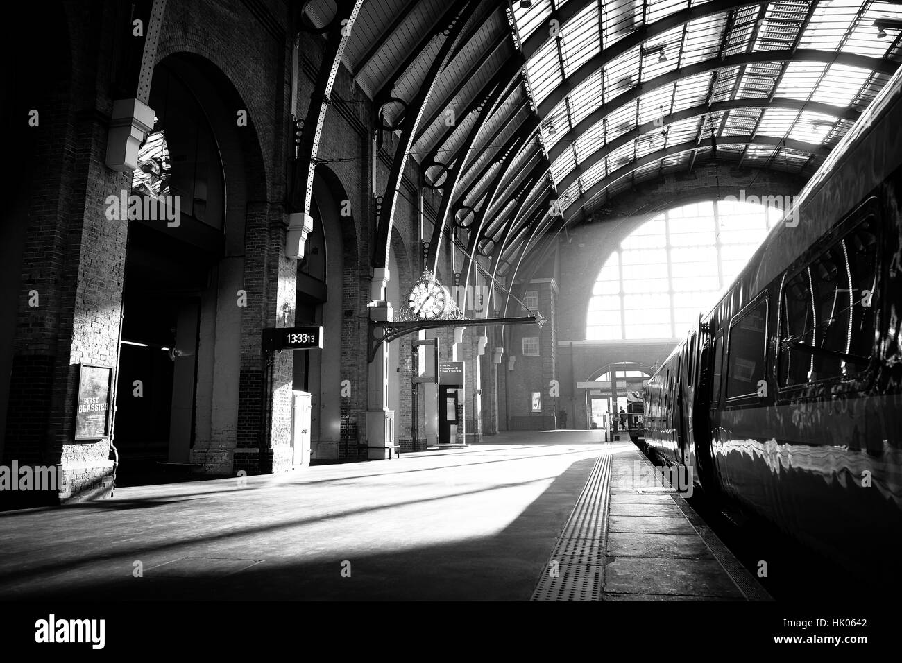 A shaft of light shines down upon a railway station platform Stock Photo