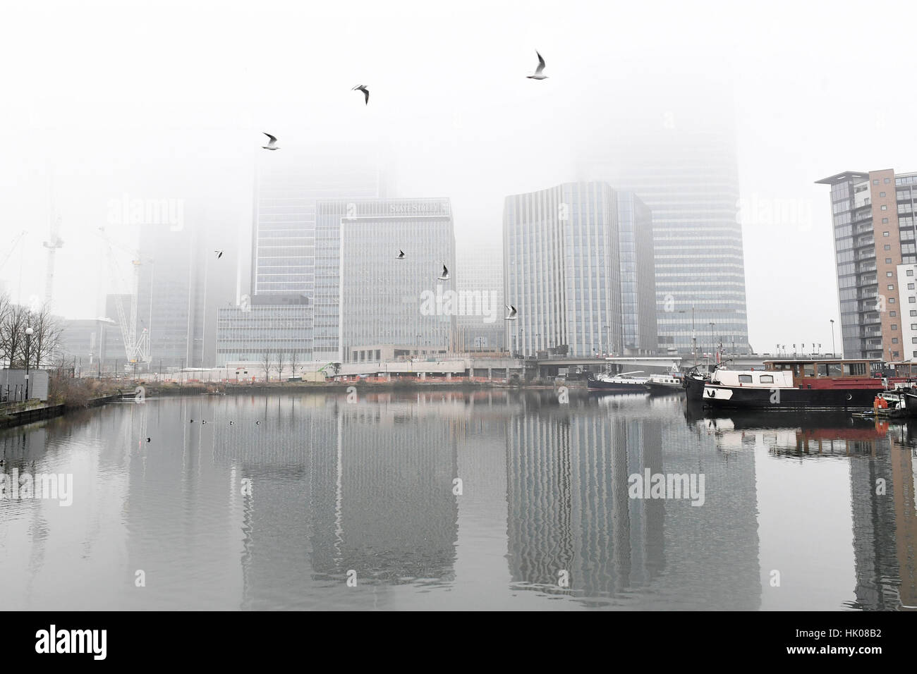 Fog clouds the view of Canary Wharf in London's Docklands. Stock Photo