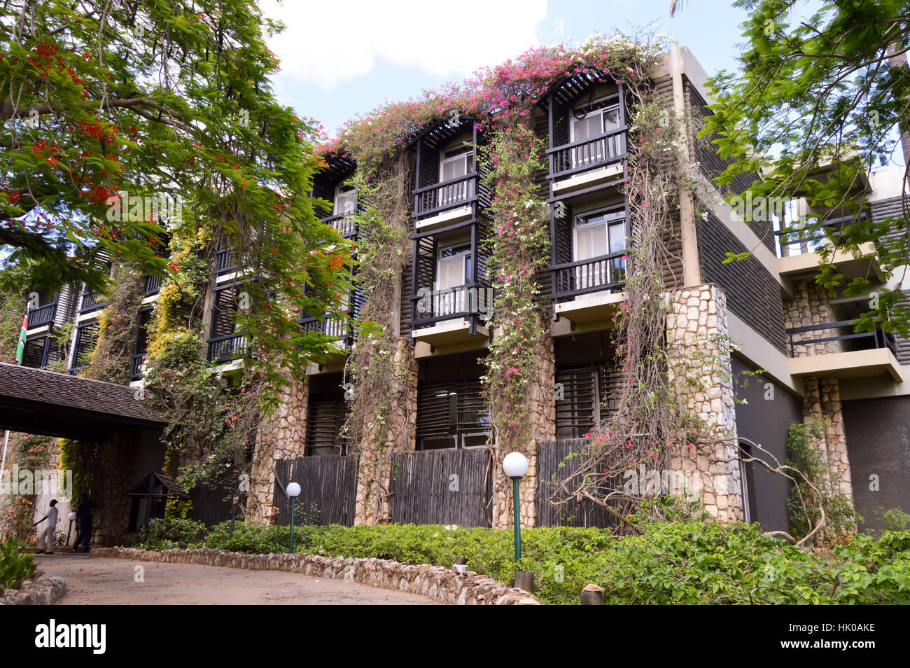 Facade with balconies completely invaded by flowers in West Tsavo Park in Kenya Stock Photo