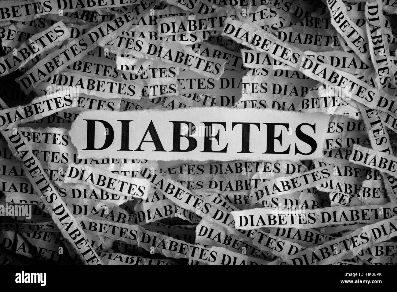DIABETES. Torn pieces of paper with the word DIABETES. Concept Image. Black and White. Closeup. Stock Photo