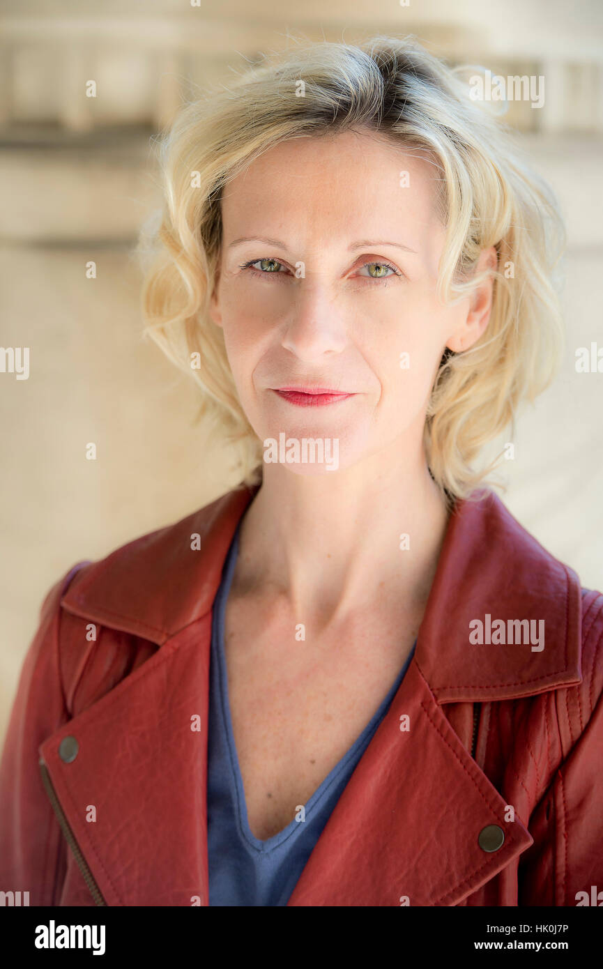 Corinne, 50-year-old woman, smiling slightly, looking at the lens. Stock Photo