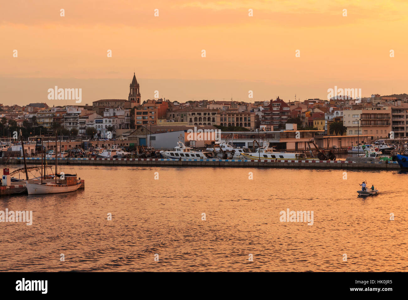 Fishing boats and town at sunrise, Palamos, Costa Brava, Girona, Catalonia, Spain Stock Photo