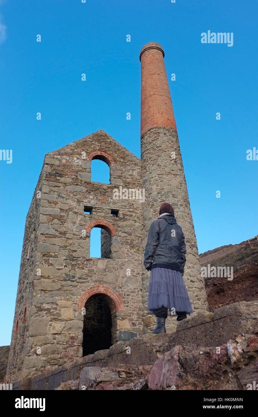 A woman looking at an old tin mine near Wheal Coates, Cornwall. Stock Photo