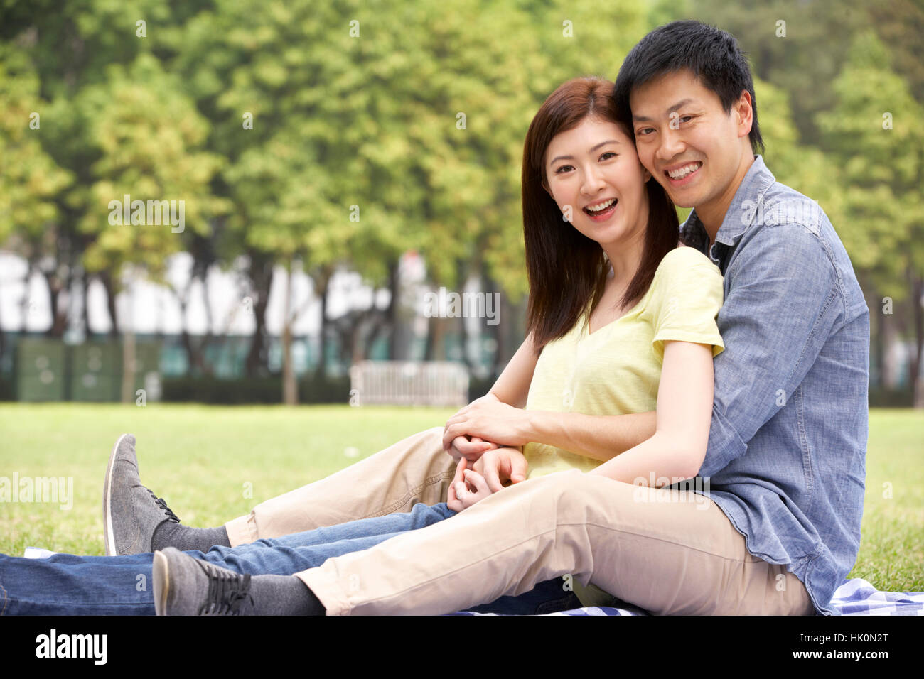 Young Chinese Couple Relaxing In Park Together Stock Photo - Alamy
