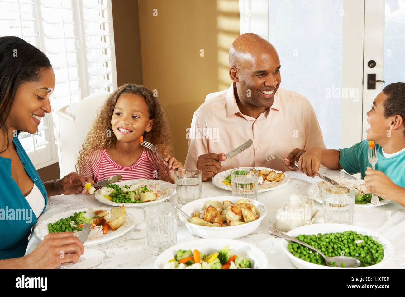 Family Enjoying Meal At Home Stock Photo - Alamy