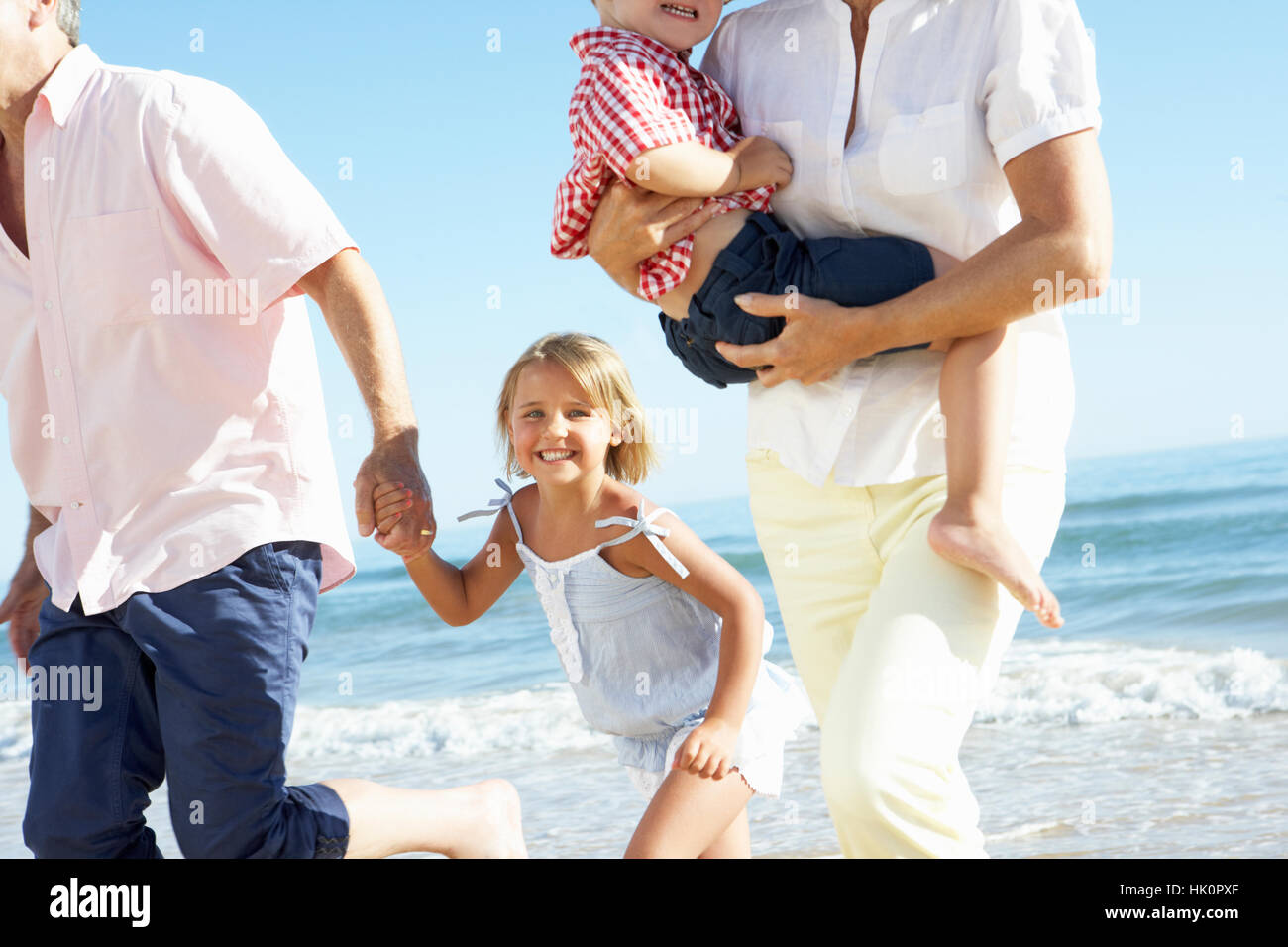 Grandparents And Grandchildren Enjoying Beach Holiday Stock Photo - Alamy