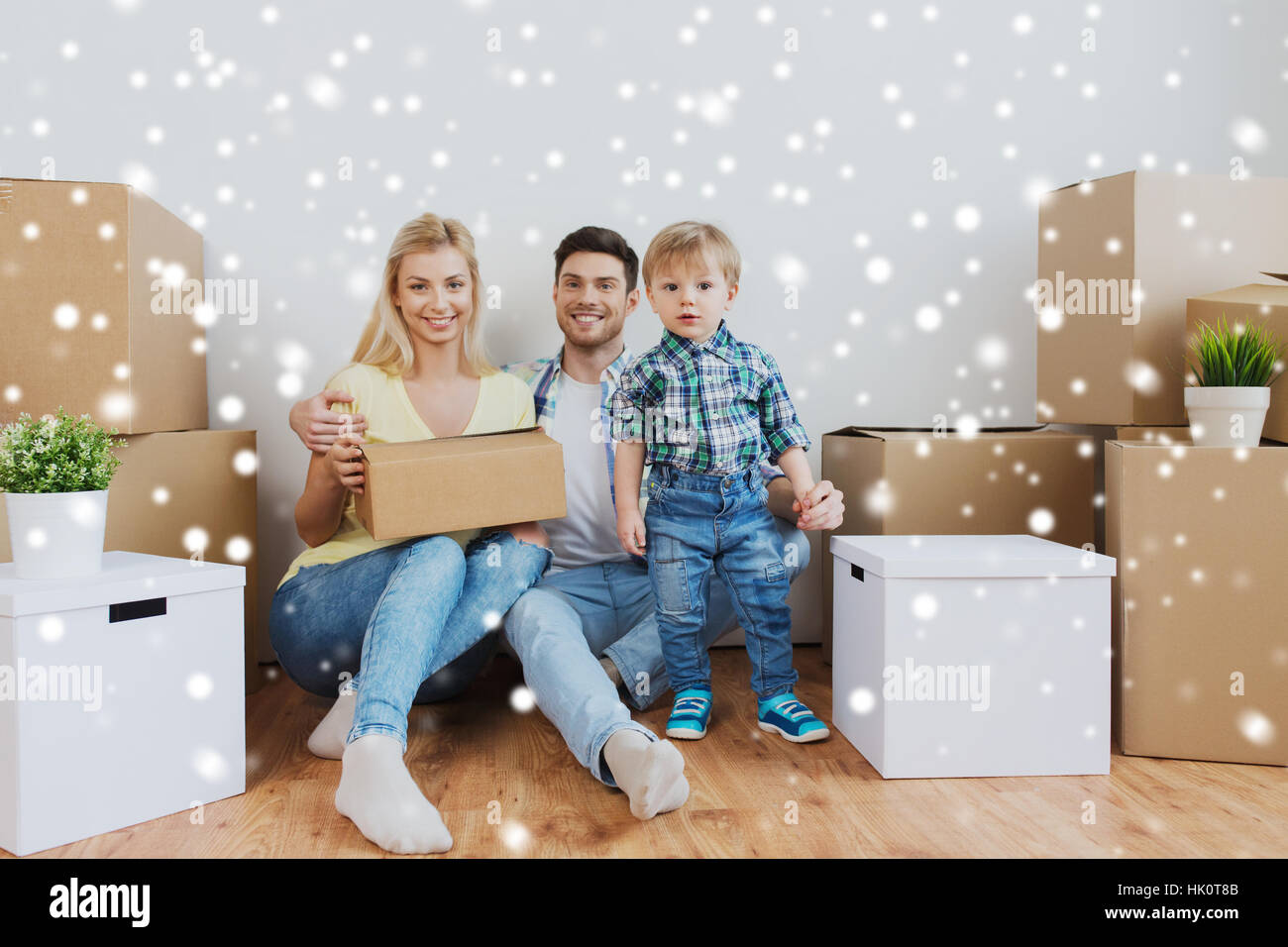 happy family with boxes moving to new home Stock Photo - Alamy