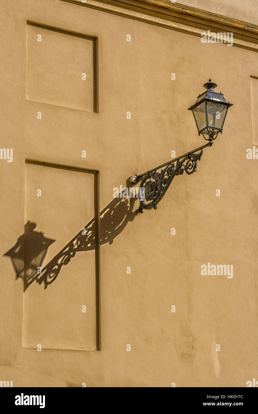 Vintage lamp with shadow on wall in Italy Stock Photo