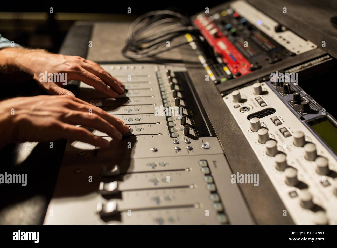 man using mixing console in music recording studio Stock Photo