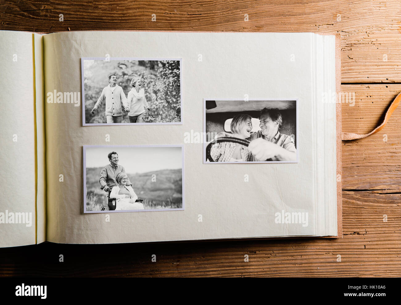 Photo album with black-and-white pictures of senior couple. Stock Photo