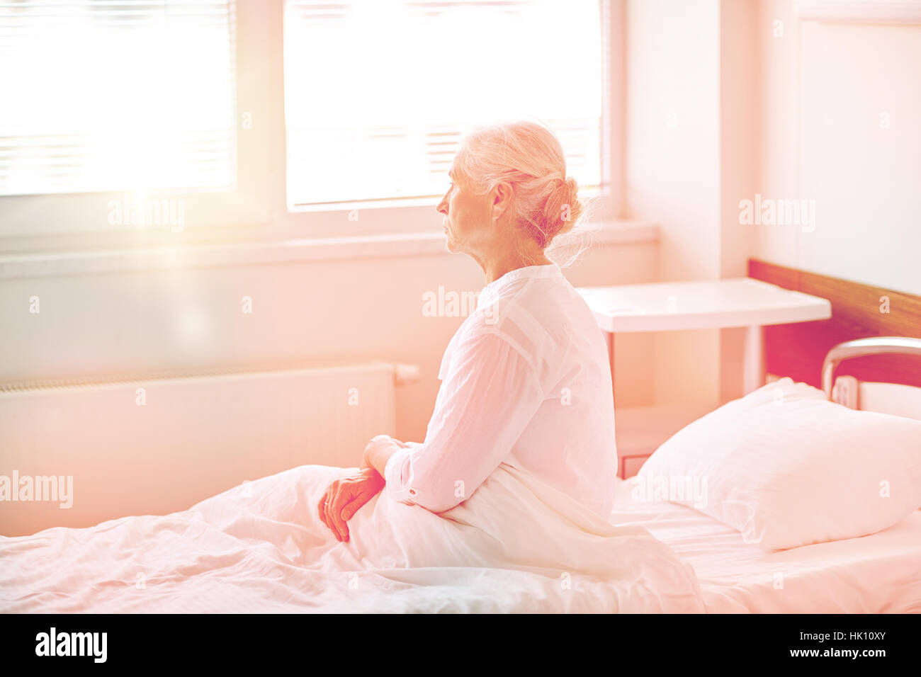 senior woman patient lying in bed at hospital ward Stock Photo
