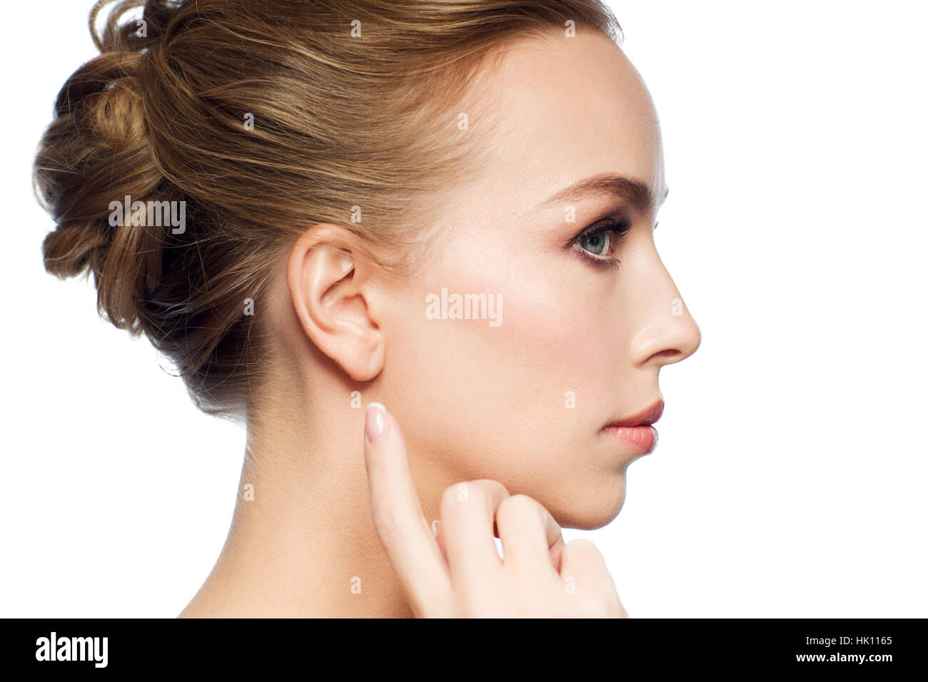 beautiful woman pointing finger to her ear Stock Photo - Alamy