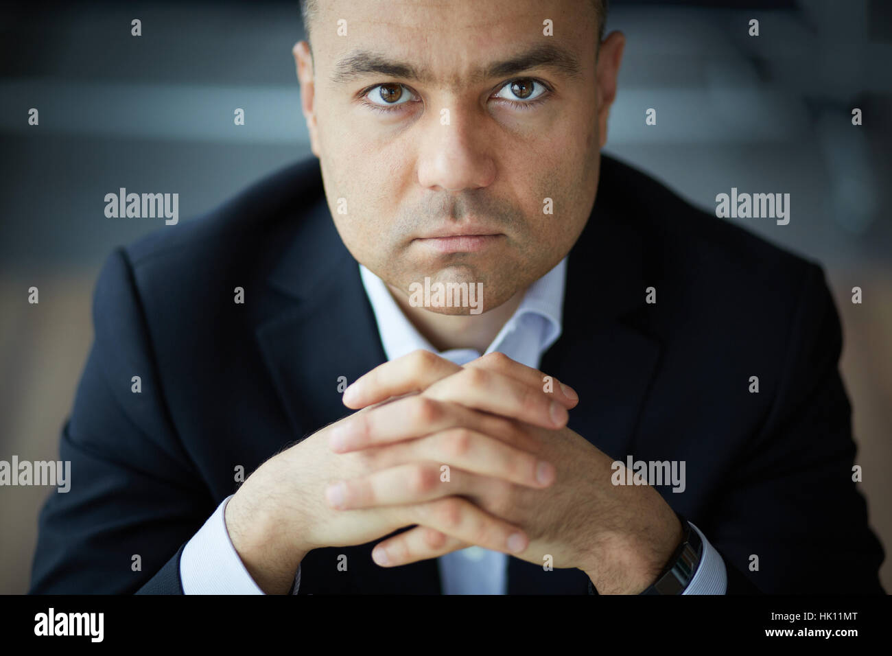 Portrait of elegant businessman looking at camera Stock Photo - Alamy