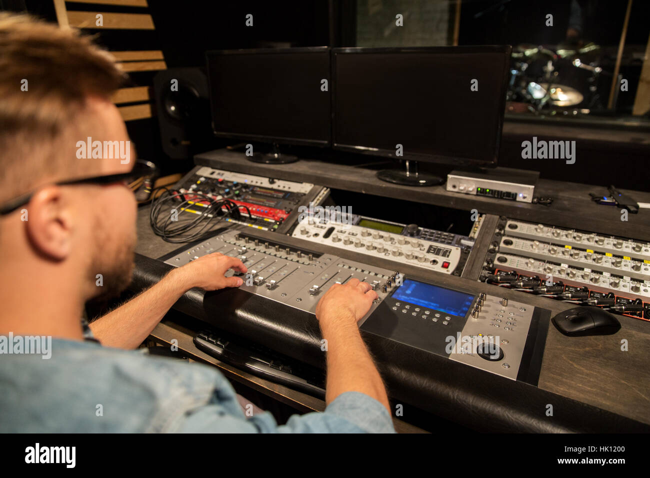 man at mixing console in music recording studio Stock Photo - Alamy