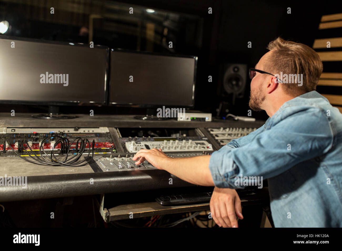man at mixing console in music recording studio Stock Photo - Alamy