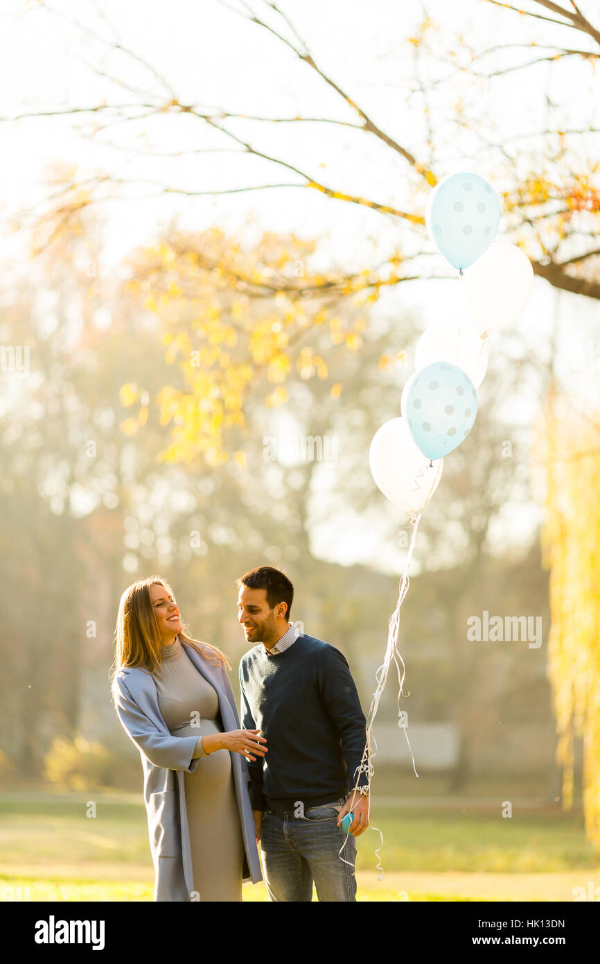 Happy loving couple with balloons in the park Stock Photo - Alamy