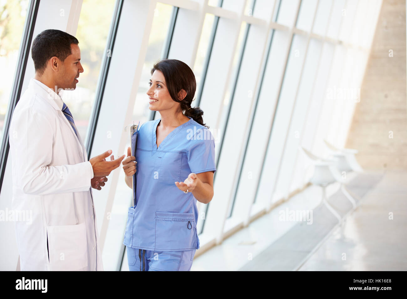 Medical Staff Having Discussion In Modern Hospital Corridor Stock Photo ...