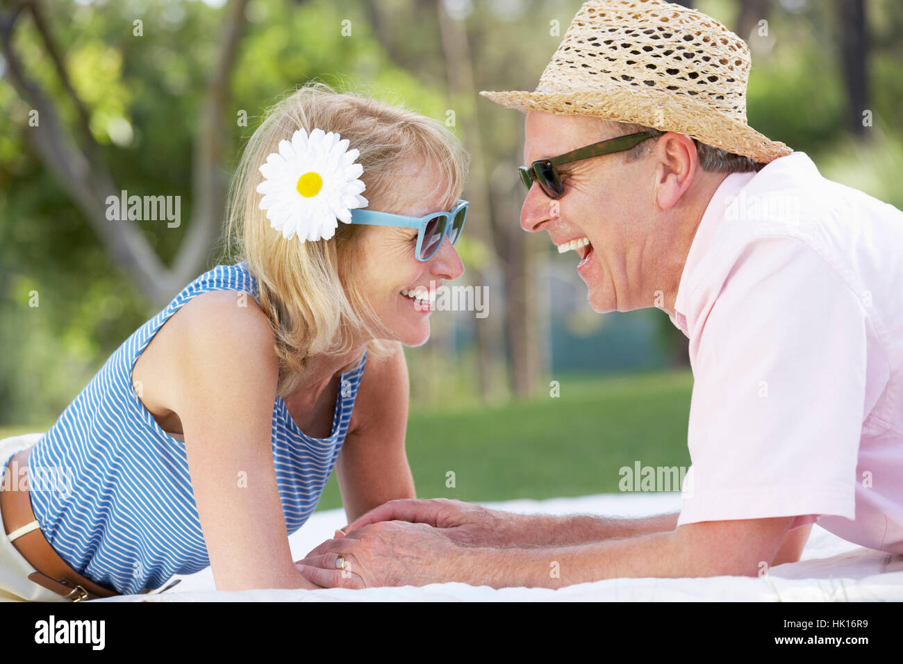 Senior Couple Relaxing In Summer Garden Stock Photo - Alamy