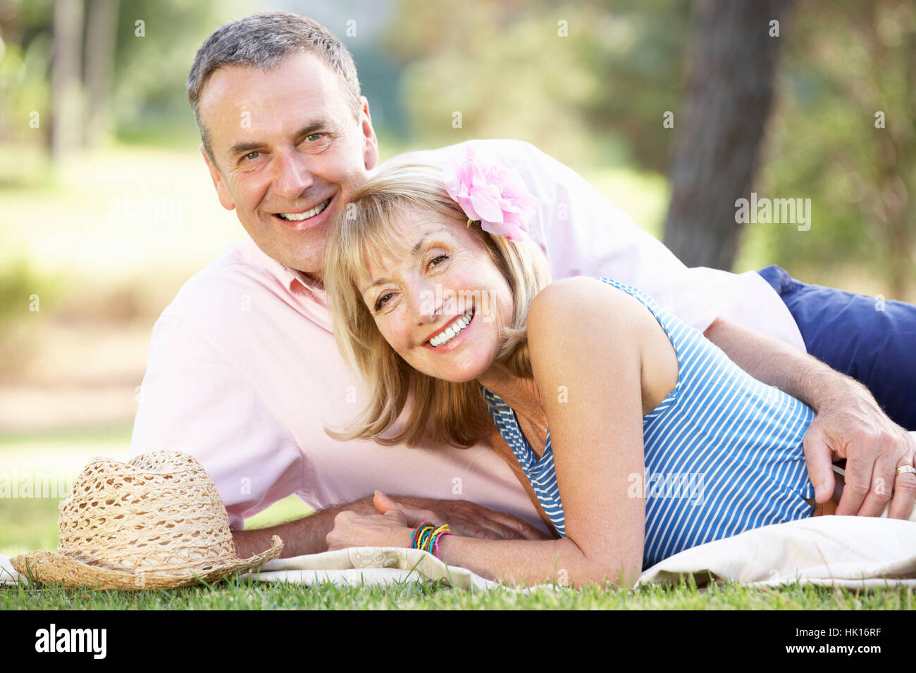Senior Couple Relaxing In Summer Garden Stock Photo - Alamy