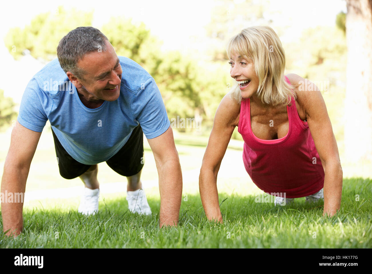 Senior Couple Exercising In Park Stock Photo - Alamy