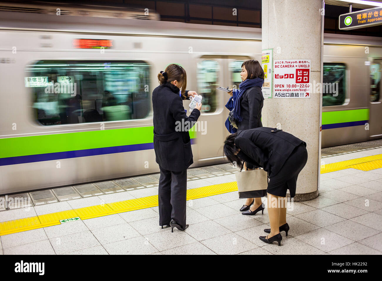 Women, a woman is drunken. Subway, in Shinjuku Sanchome station, Toei Shinjuku line, Tokyo, Japan. Stock Photo