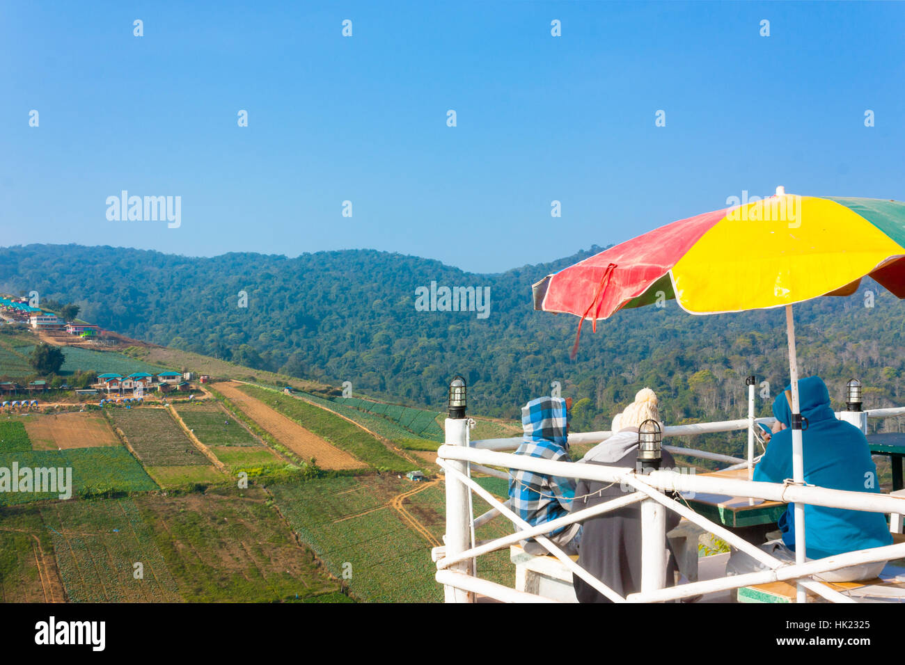 Three Tourists Sit On Viewpoint Of Phu Thap Boek --- Tourist Attraction In Petchabun, Thailand Stock Photo