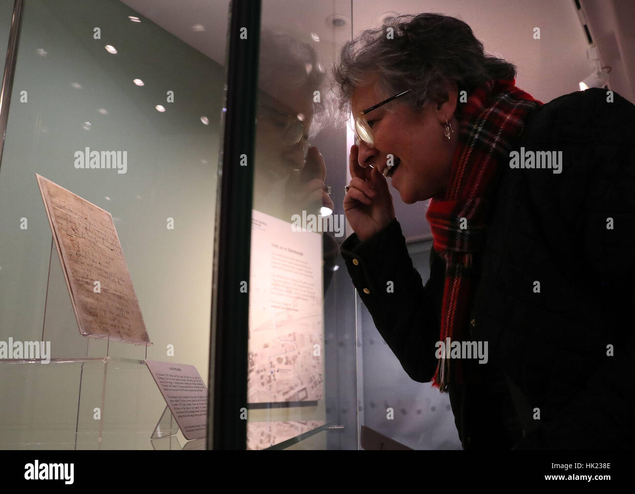 Robert Burns fan Marie McGhee from Glasgow views a manuscript of Ae Fond Kiss written by the bard for his departed love Agnes McLehose which went on public display for a couple of hours at Kelvin Hall in the National Library of Scotland, Glasgow. Stock Photo