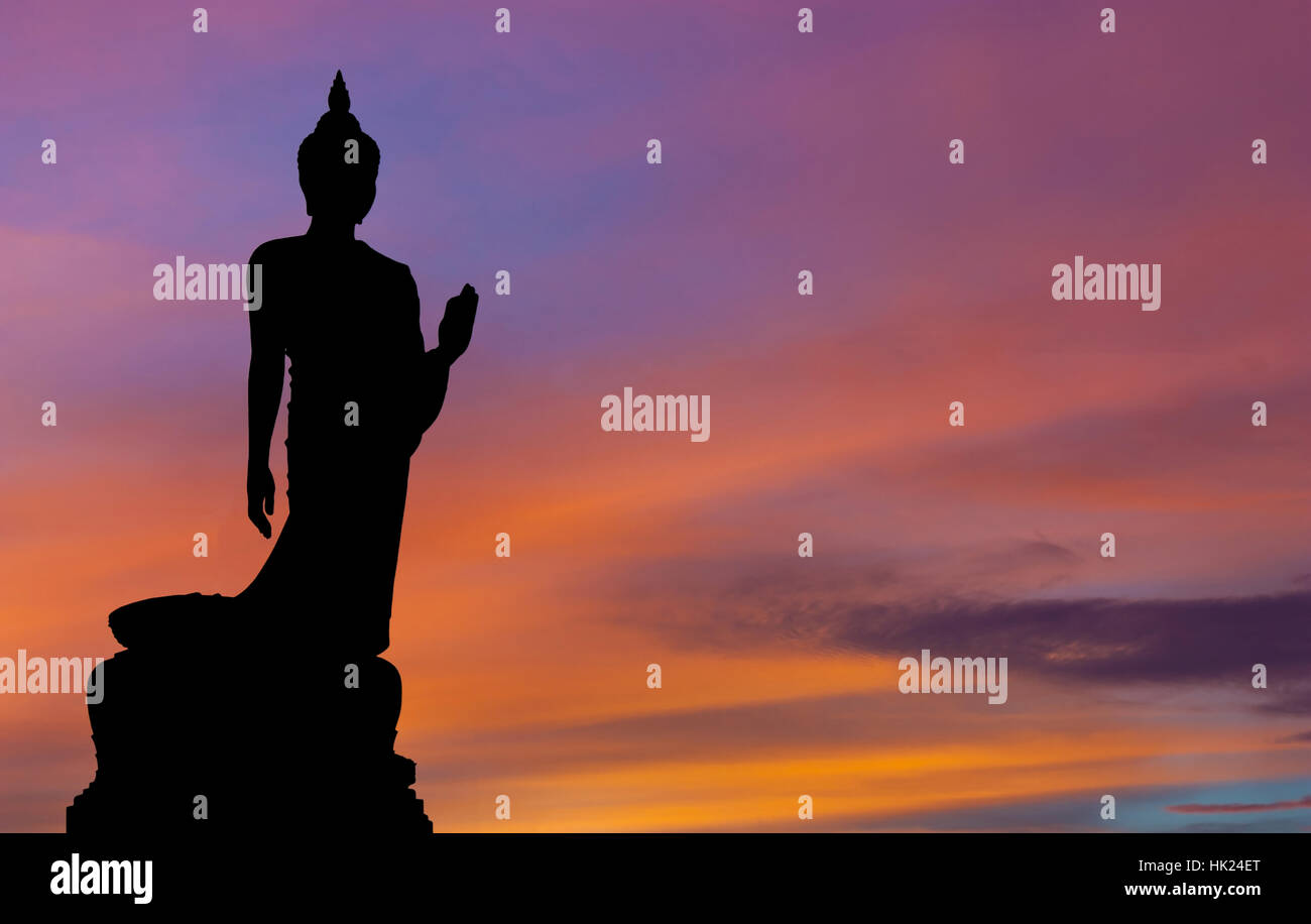 The Posture Of Walking Buddhist Statue In Twilight Silhouette Stock Photo