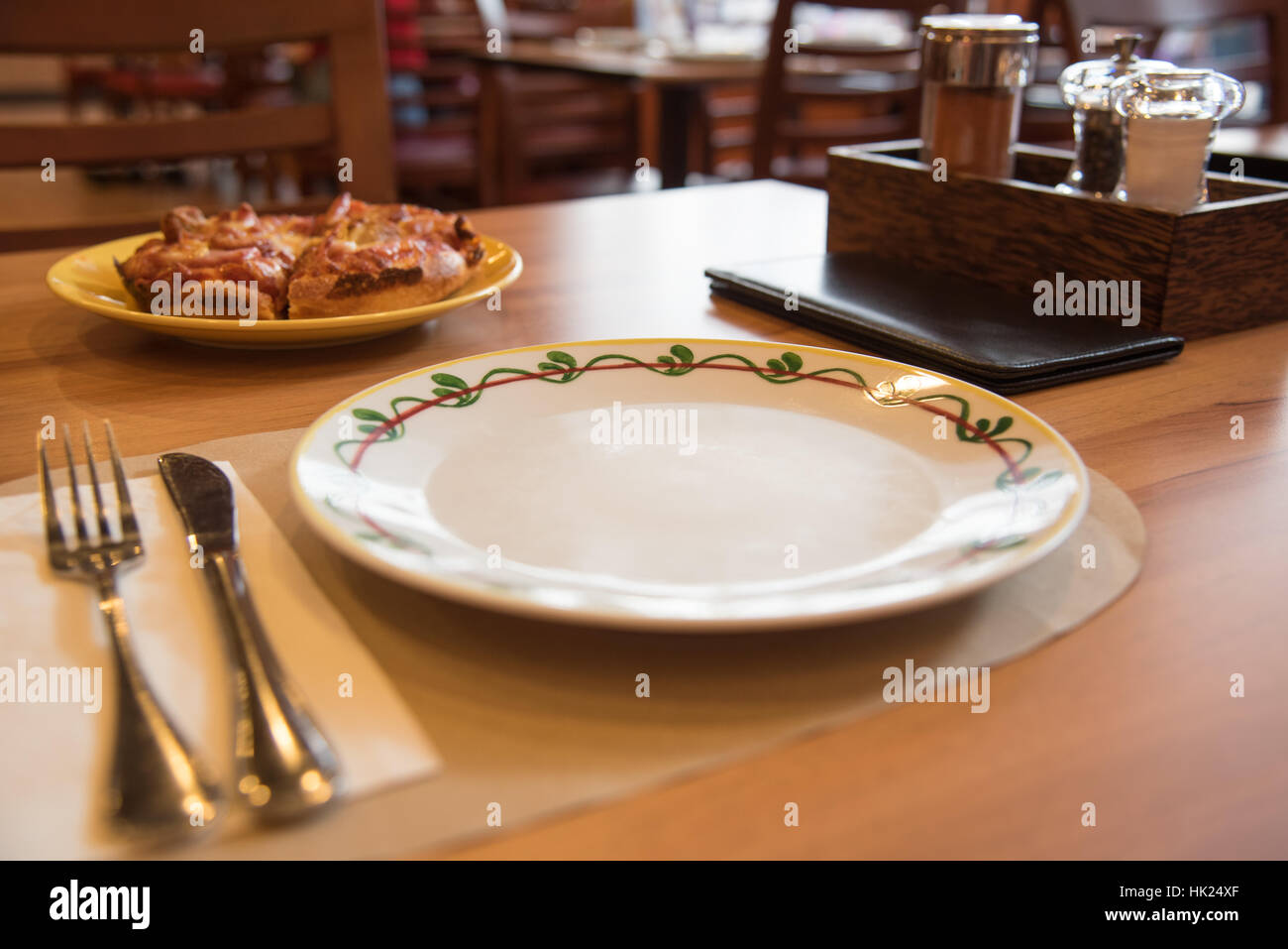 Selective Focus On Dish On Restaurant Wooden Table With Tableware, Seasoning Bottles Stock Photo