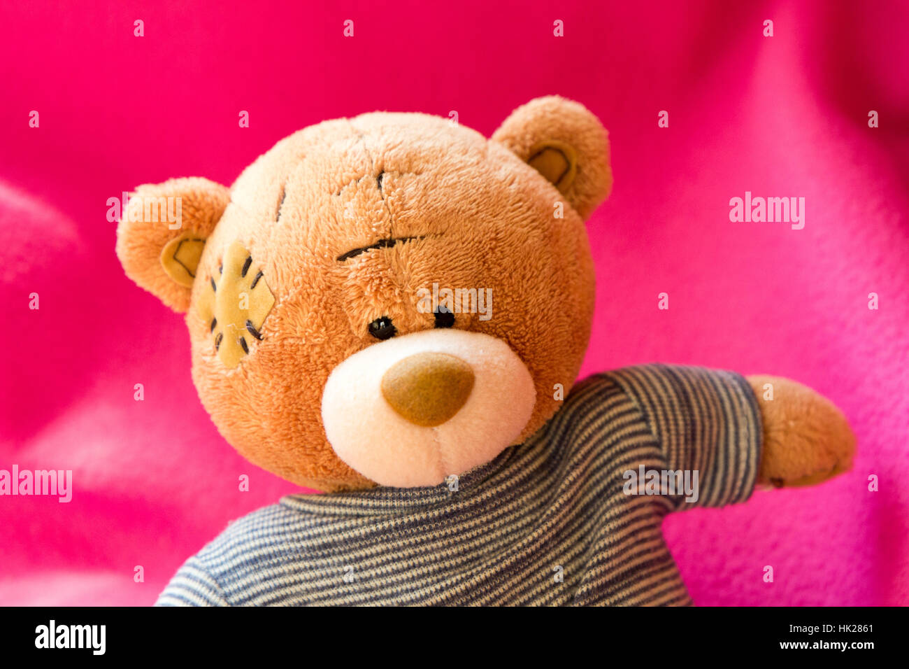 A cute 'me to you' teddy bear on a pink background. Stock Photo