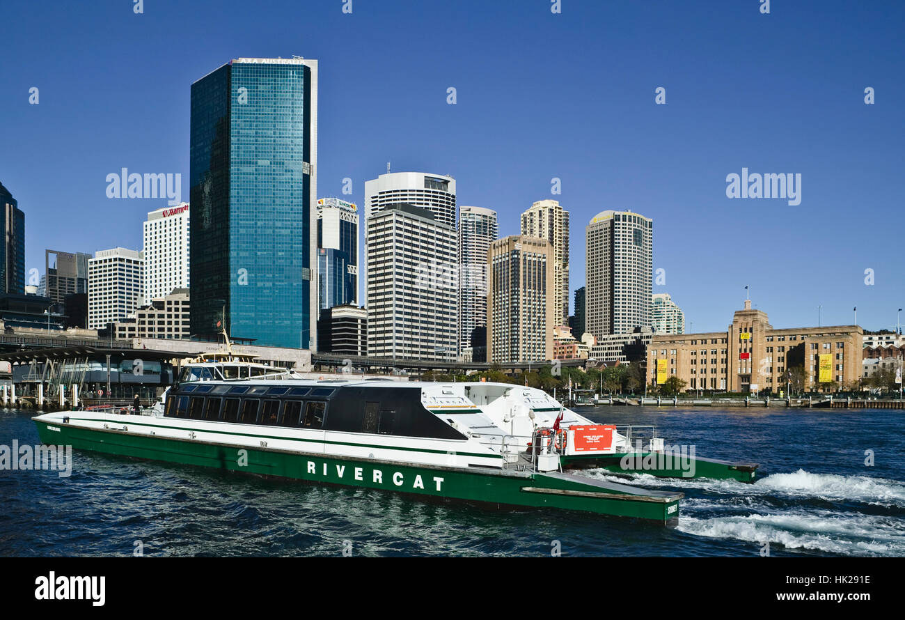 A Rivercat ferry pulling in to Circular Quay in Sydney Australia with city in background Stock Photo