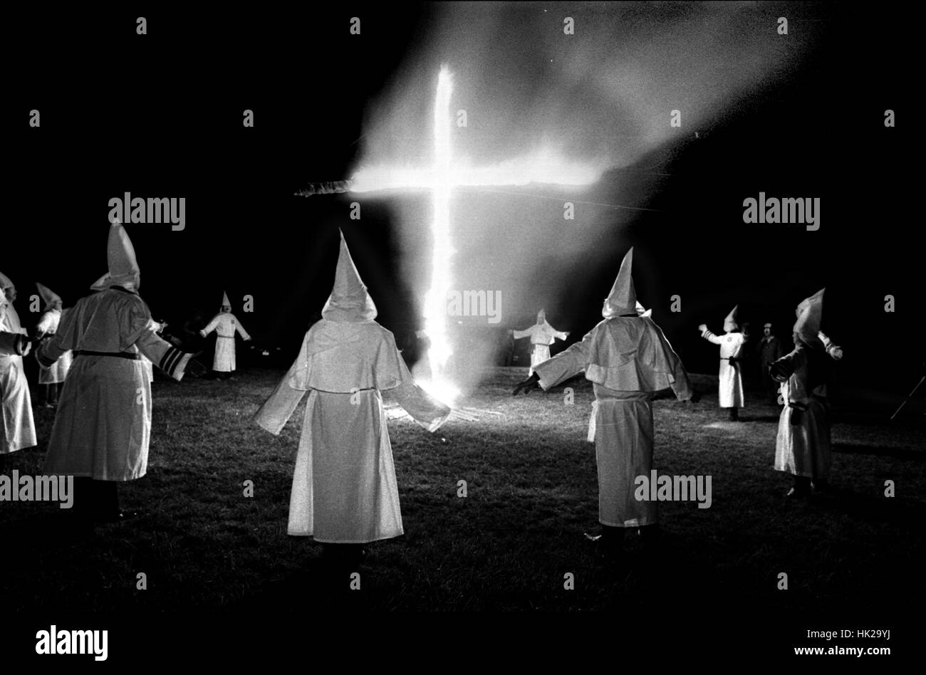 Members of the KKK circle a cross lighting in Rumford Me during rally in the small town Maine town. The Klan had been active in Maine in the 1920's and 30's , This group of Klansmen openly invited the press to observe ,photograph and report on this event photo by bill belknap Stock Photo