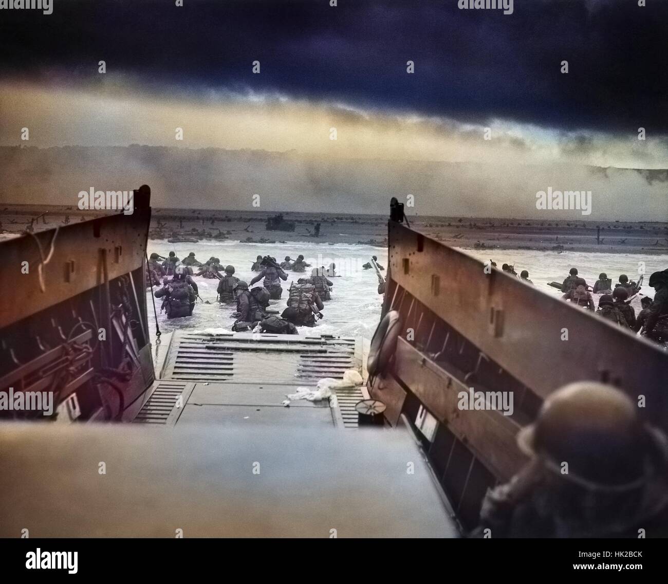 Digitally colorized image of Into the Jaws of Death, a photograph by Robert F Sargent of the United States Army First Infantry Division disembarking from an LCVP (landing craft) onto Omaha Beach during the Normandy Landings on D Day during World War 2, June 6, 1944. Stock Photo