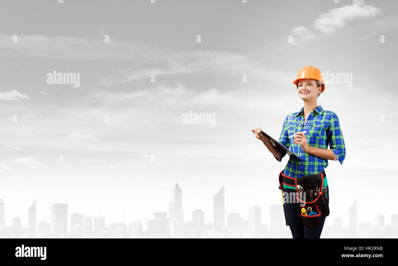 Attractive woman engineer making some notes and sketches Stock Photo ...