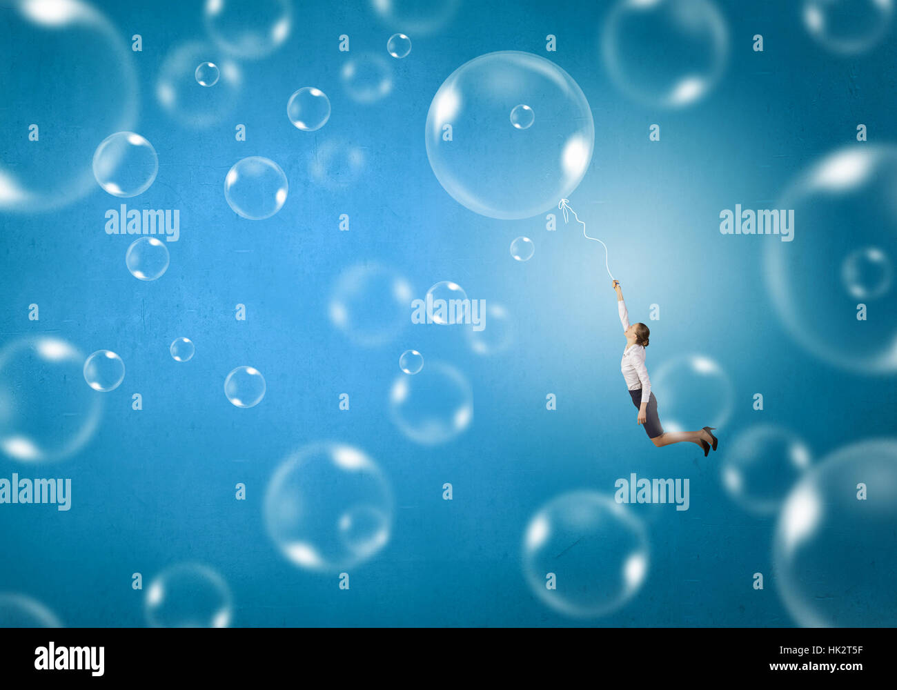 Young businesswoman flying high in sky on soap bubble Stock Photo - Alamy