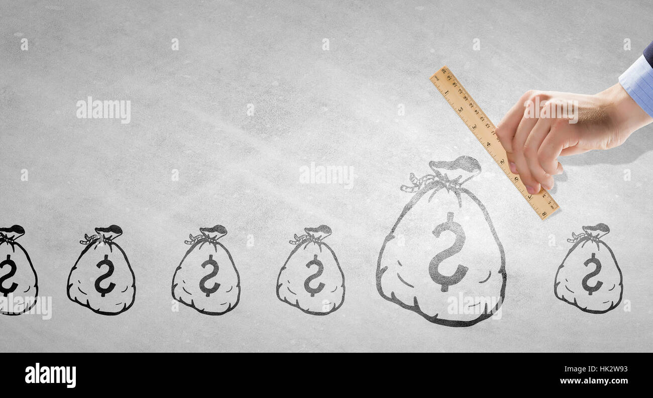 Money Ruler Close up of human hand measuring money bag with ruler Stock Photo - Alamy