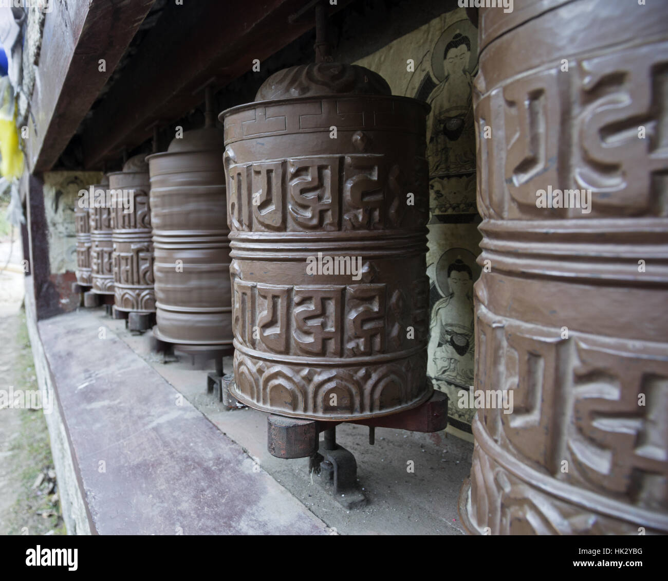 prayer wheels in Nepal with motion blur on one turning wheel Stock Photo