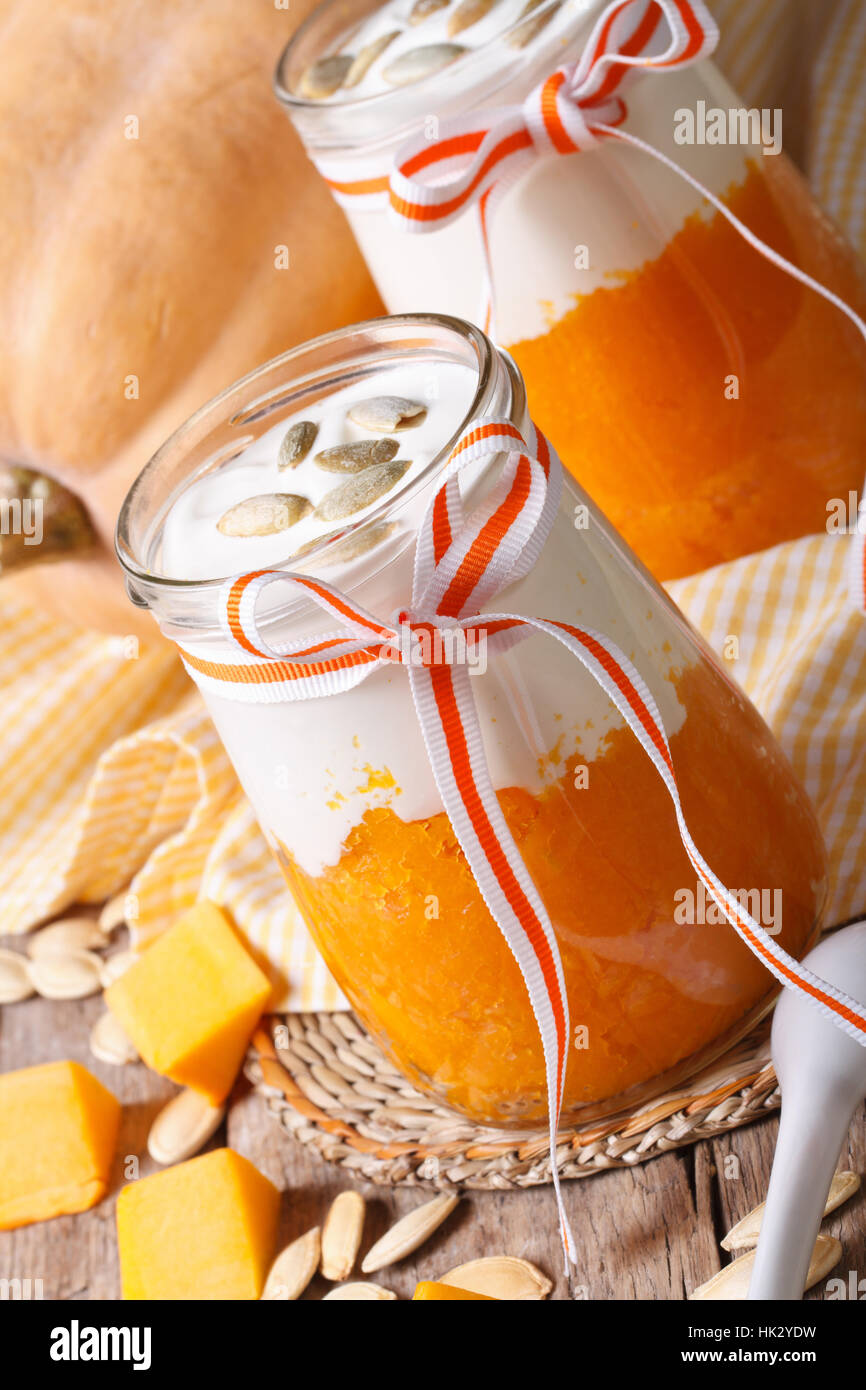 Delicious pumpkin smoothies, yogurt and seeds close up. vertical Stock Photo