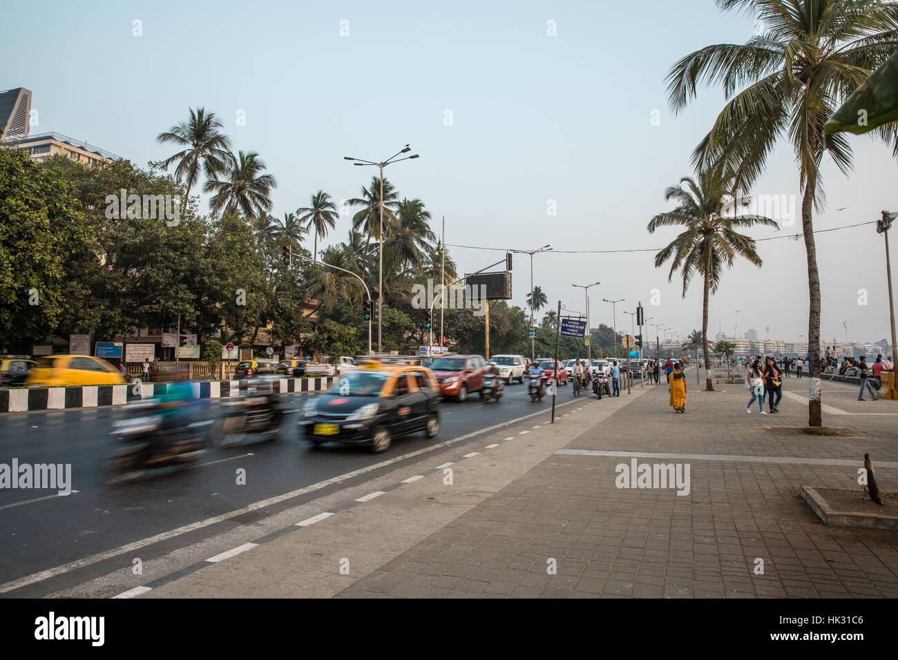 Cars and buses speed down Marine Drive in Mumbai (formerly Bombay), India. Stock Photo