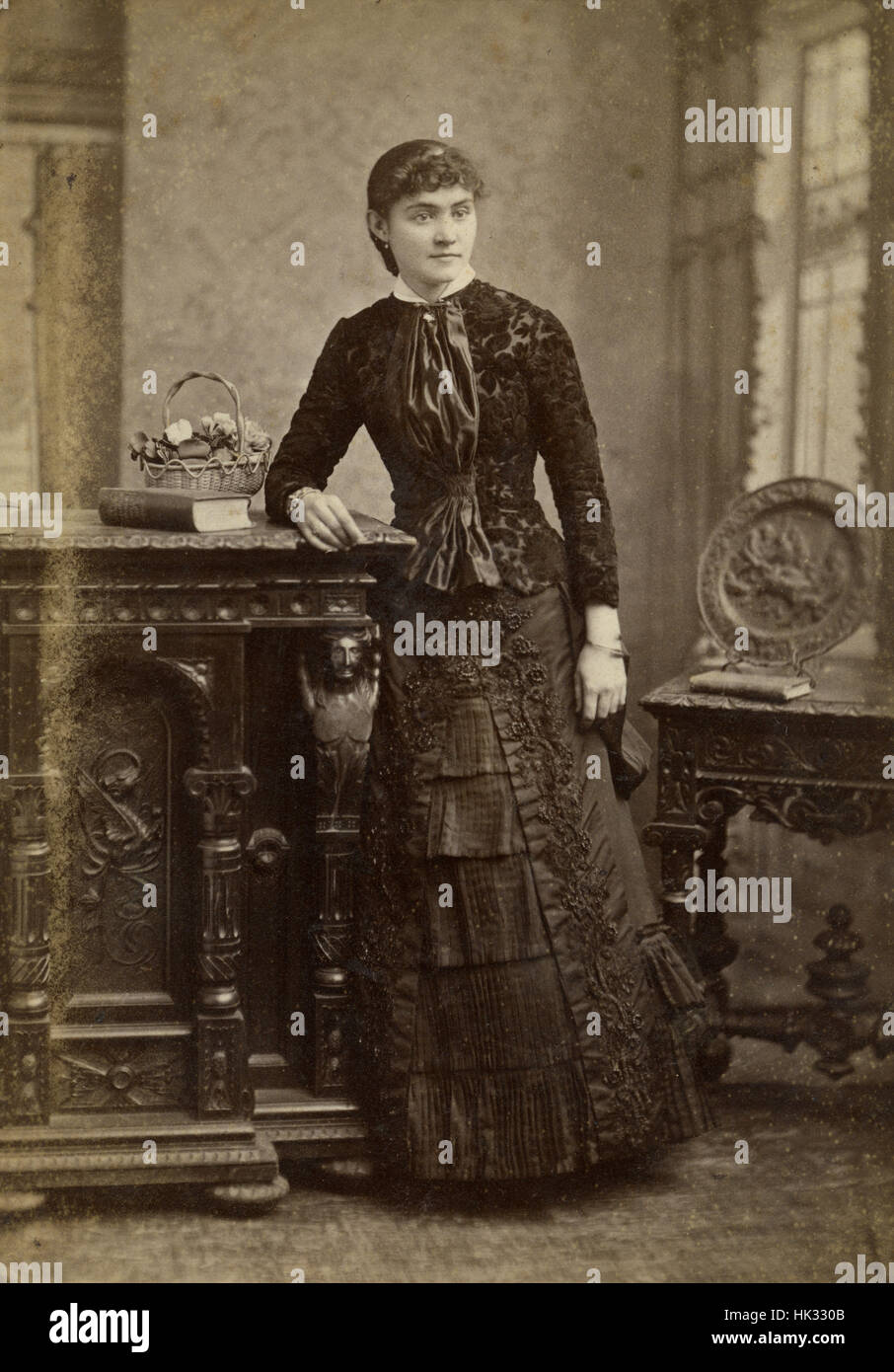 Antique c1890 cabinet card photograph, finely dressed young woman in Boston, Massachusetts, USA. Stock Photo