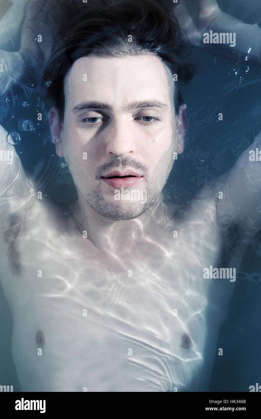 Portrait of a young man in the clear water Stock Photo